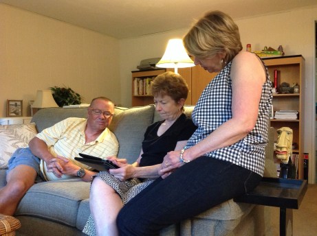 Phil, Virginia and Kathleen looking at pictures from cruise.